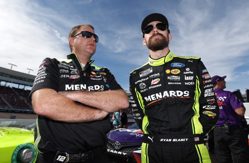 AVONDALE, ARIZONA - NOVEMBER 05: Ryan Blaney, driver of the #12 Menards/Dutch Boy Ford, and a crew member talk on the grid during qualifying for the NASCAR Cup Series Championship at Phoenix Raceway on November 05, 2022 in Avondale, Arizona. (Photo by Christian Petersen/Getty Images) | Getty Images