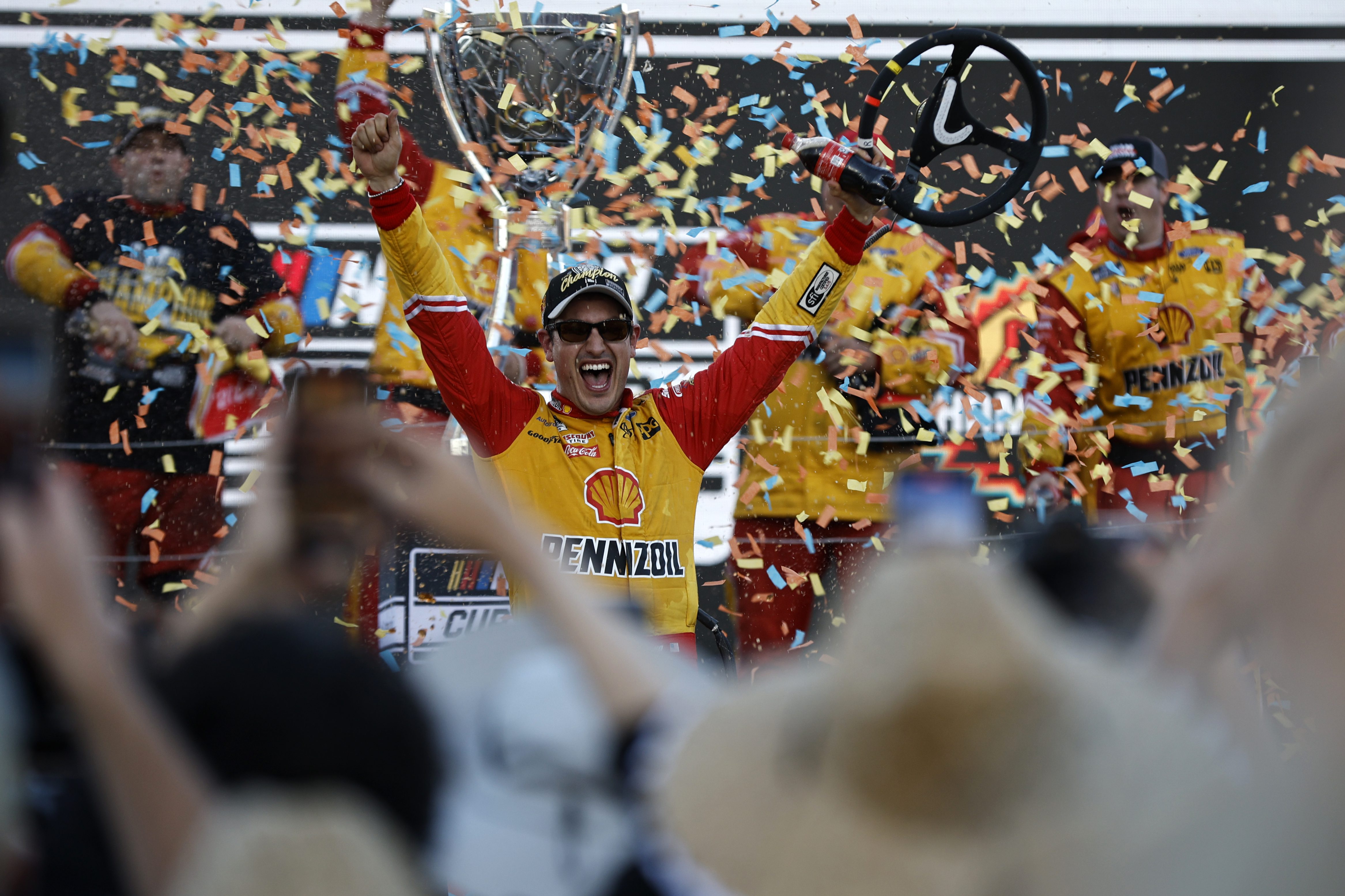 Joey Logano celebrates in victory lane after winning the 2022 NASCAR Cup Series Championship at Phoenix Raceway.