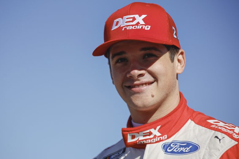 TALLADEGA, ALABAMA - OCTOBER 01: Harrison Burton, driver of the #21 DEX Imaging Ford, walks the grid during qualifying for the NASCAR Cup Series YellaWood 500 at Talladega Superspeedway on October 01, 2022 in Talladega, Alabama. (Photo by Sean Gardner/Getty Images) | Getty Images
