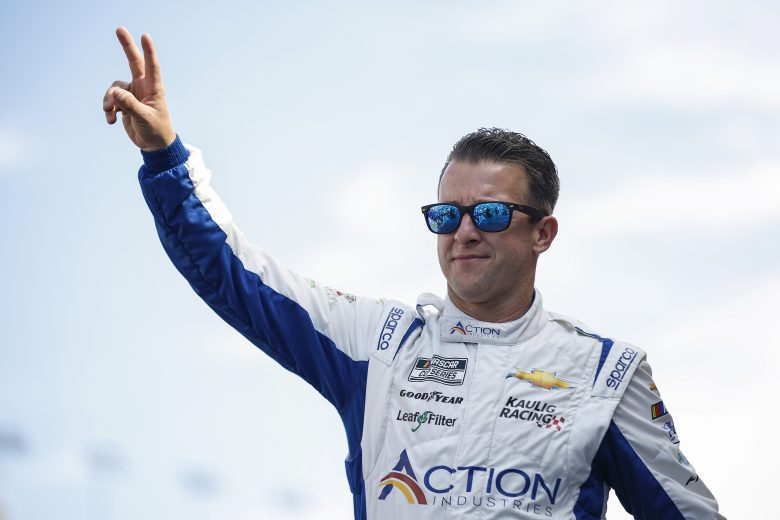 LAS VEGAS, NEVADA - OCTOBER 16: AJ Allmendinger, driver of the #16 Action Industries Chevrolet, waves to fans as he walks onstage during driver intros prior to the NASCAR Cup Series South Point 400 at Las Vegas Motor Speedway on October 16, 2022 in Las Vegas, Nevada. (Photo by Sean Gardner/Getty Images) | Getty Images