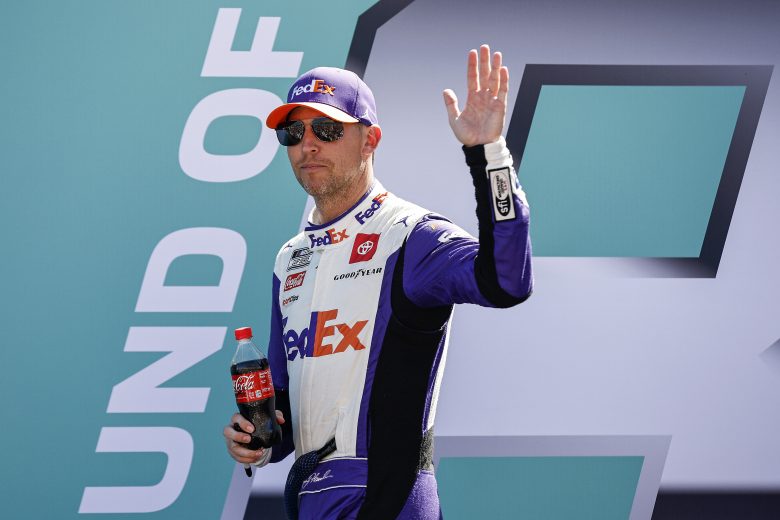 HOMESTEAD, FLORIDA - OCTOBER 23: Denny Hamlin, driver of the #11 FedEx Ground Toyota, waves to fans as he walks onstage during driver intros prior to the NASCAR Cup Series Dixie Vodka 400 at Homestead-Miami Speedway on October 23, 2022 in Homestead, Florida. (Photo by Sean Gardner/Getty Images) | Getty Images