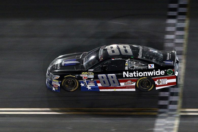 DAYTONA BEACH, FL - JULY 06:  Dale Earnhardt Jr., driver of the #88 Nationwide Stars and Stripes Chevrolet, takes the checkered flag to win the NASCAR Sprint Cup Series Coke Zero 400 Powered by Coca-Cola at Daytona International Speedway on July 6, 2015 in Daytona Beach, Florida.  (Photo by Patrick Smith/Getty Images) | Getty Images