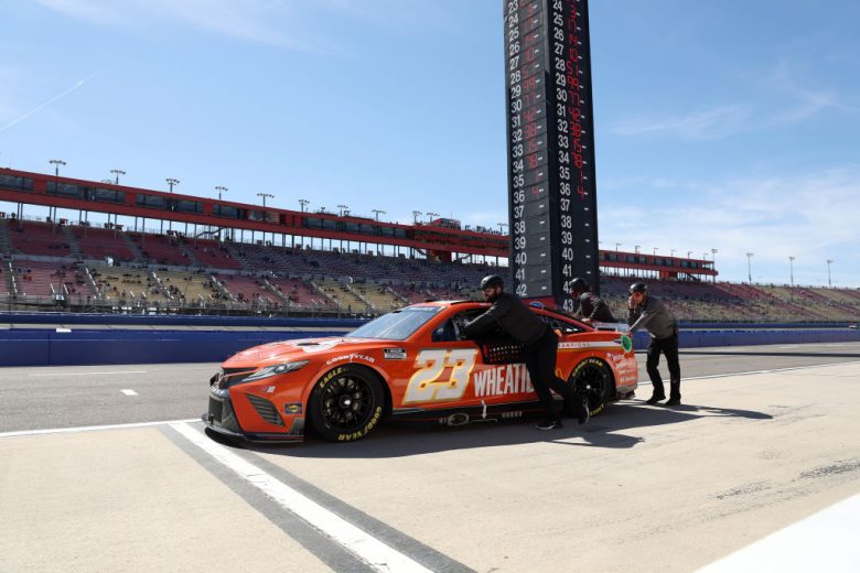 FONTANA, CALIFORNIA - FEBRUARY 26: Crew members push the #23 Wheaties Toyota, driven by Bubba Wallace on the grid during practice for the NASCAR Cup Series Wise Power 400 at Auto Club Speedway on February 26, 2022 in Fontana, California. (Photo by James Gilbert/Getty Images) | Getty Images
