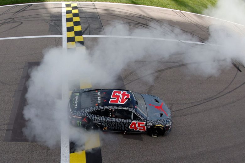 KANSAS CITY, KANSAS - MAY 15: Kurt Busch, driver of the #45 Jordan Brand Toyota, celebrates with a burnout after winning the NASCAR Cup Series AdventHealth 400 at Kansas Speedway on May 15, 2022 in Kansas City, Kansas. (Photo by Sean Gardner/Getty Images) | Getty Images