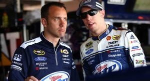 Crew chief Paul Wolfe and Brad Keselowski talk in the garage at Dover Motor Speedway in 2013