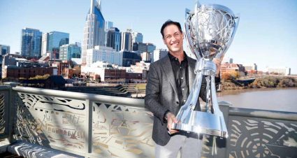 Joey Logano poses with trophy in Nashville