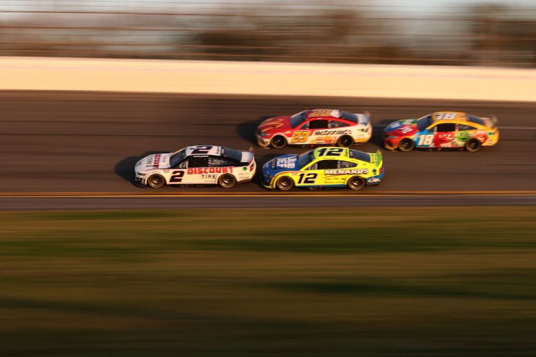 DAYTONA BEACH, FLORIDA - FEBRUARY 20: Austin Cindric, driver of the #2 Discount Tire Ford, Ryan Blaney, driver of the #12 Menards/Blue DEF/PEAK Ford, Bubba Wallace, driver of the #23 McDonald's Toyota, and Kyle Busch, driver of the #18 M&M's Toyota,race during the NASCAR Cup Series 64th Annual Daytona 500 at Daytona International Speedway on February 20, 2022 in Daytona Beach, Florida. (Photo by James Gilbert/Getty Images) | Getty Images