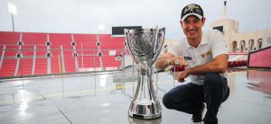 joey Logano with his championship trophy at the coliseum