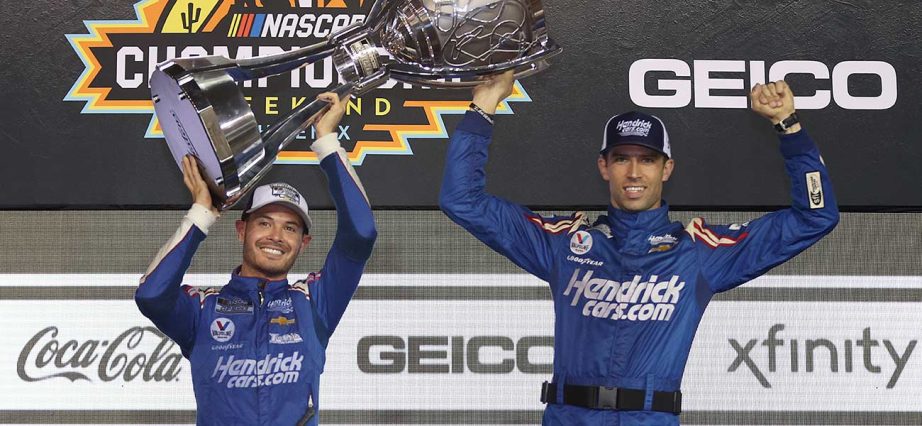 yle Larson, driver of the #5 HendrickCars.com Chevrolet, and crew chief Cliff Daniels celebrate in victory lane after winning the NASCAR Cup Series Championship at Phoenix Raceway on November 07, 2021