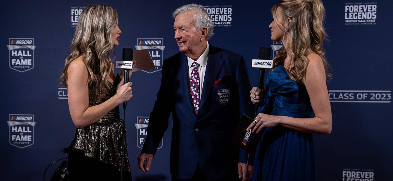 Hershel McGriff is interviewed by Kim Coon, left, and Alex Weaver on the NASCAR Hall of Fame red carpet