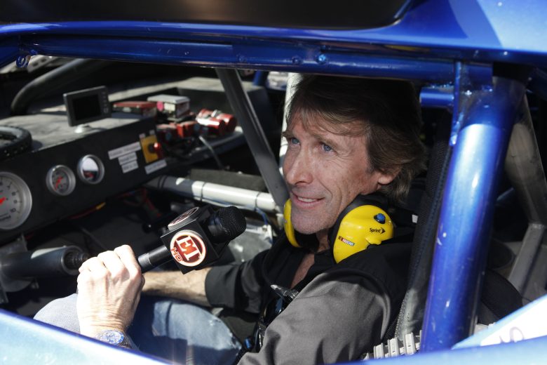 DAYTONA BEACH, FL - FEBRUARY 20: Director Michael Bay, poses in the Transformer Wrecker before the Daytona 500 at Daytona International Speedway on February 20, 2011 in Daytona Beach, Florida. (Photo by Brandon Goodman/Getty Images)