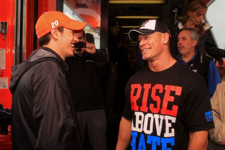 DAYTONA BEACH, FL - FEBRUARY 26: Joey Logano (L), driver of the #20 The Home Depot Toyota, speaks to professional wrestler John Cena in the garage area prior to the start of the NASCAR Sprint Cup Series Daytona 500 at Daytona International Speedway on February 26, 2012 in Daytona Beach, Florida. (Photo by Matthew Stockman/Getty Images)