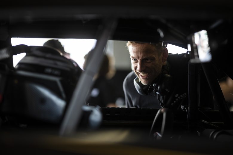 DAYTONA BEACH, FLORIDA - JANUARY 31: Jenson Button (R) talks to Mike Rockenfeller in the garage during the NASCAR Garage 56 Test at Daytona International Speedway on January 31, 2023 in Daytona Beach, Florida.