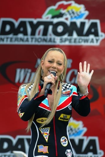 DAYTONA, FL - FEBRUARY 16: Recording artist Mariah Carey speaks during the pre race ceremonies at during the NASCAR Winston Cup Daytona 500 on February 16, 2003 at the Daytona International Speedway in Daytona, Florida. (Photo by Jamie Squire/Getty Images).