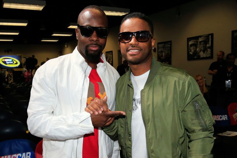 DAYTONA BEACH, FL - FEBRUARY 21: Wyclef Jean poses with Larenz Tate at the driver's meeting prior to the NASCAR Sprint Cup Series DAYTONA 500 at Daytona International Speedway on February 21, 2016 in Daytona Beach, Florida. (Photo by Chris Trotman/NASCAR via Getty Images)