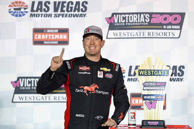 Kyle Busch poses with trophy