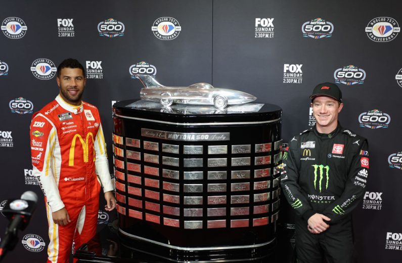 Bubba Wallace and Tyler Reddick pose with the Harley J. Earl Trophy