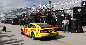 joey logano drives through the garage