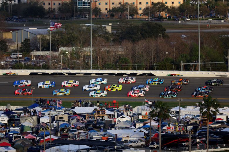 A pack of cars race at Daytona