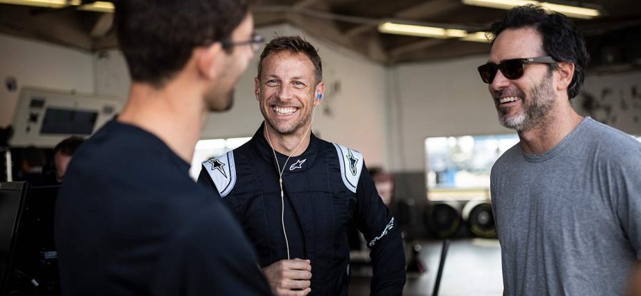 Jimmie Johnson, Jenson Button and Jordan Taylor chat in the Daytona International Speedway garage