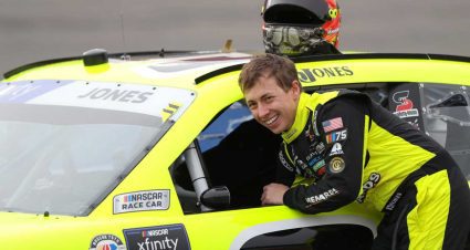 Brandon Jones reaches into his race car at Auto Club Speedway