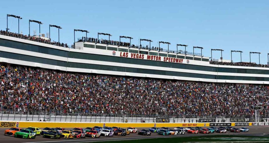 Cars race down Las Vegas Speedway frontstretch
