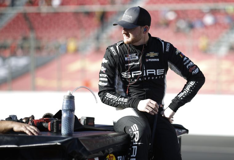 ty dillon sits on a wall