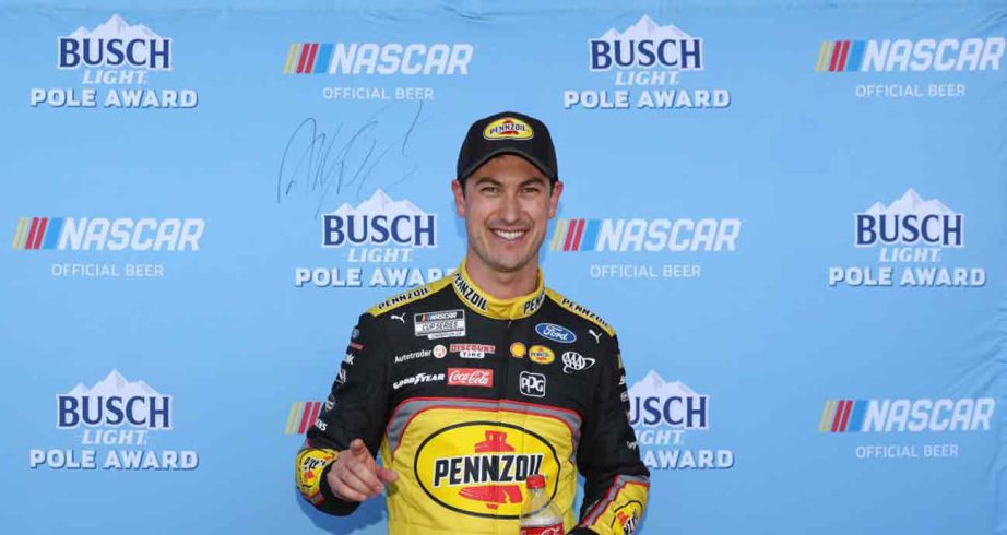 Joey Logano, driver of the #22 Pennzoil Ford, poses for photos after winning the pole award during practice for the NASCAR Cup Series Pennzoil 400 at Las Vegas Motor Speedway.