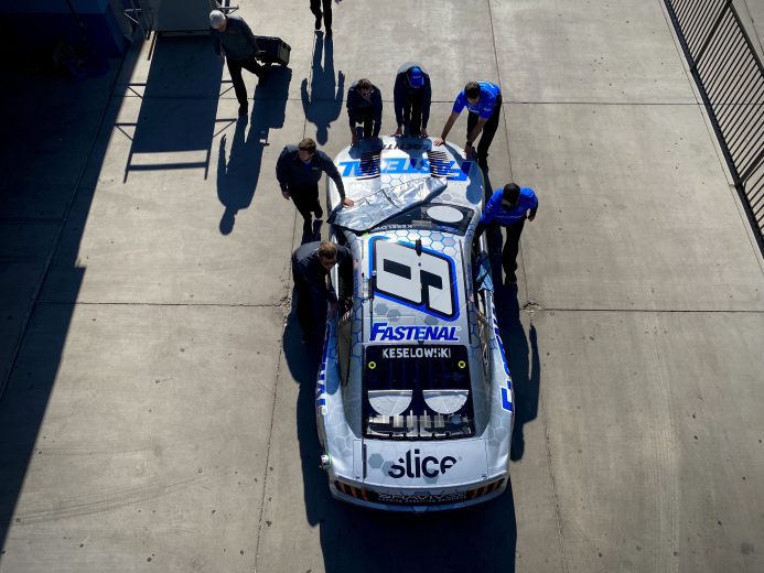 Crew members work on Brad Keselowski's No. 6 Ford at Las Vegas Motor Speedway.