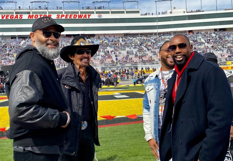 Richard Petty stands with delegates from the Wendell Scott Foundation.