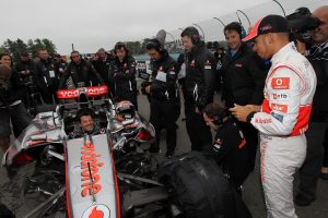 In this 2011 photo, Tony Stewart sits in Lewis Hamilton's 2008 F1 car and speaks with Hamilton during a seat swap at Watkins Glen