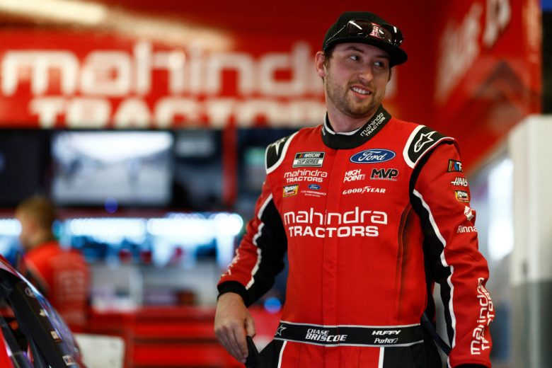 Chase Briscoe stands in garage at Daytona International Speedway.