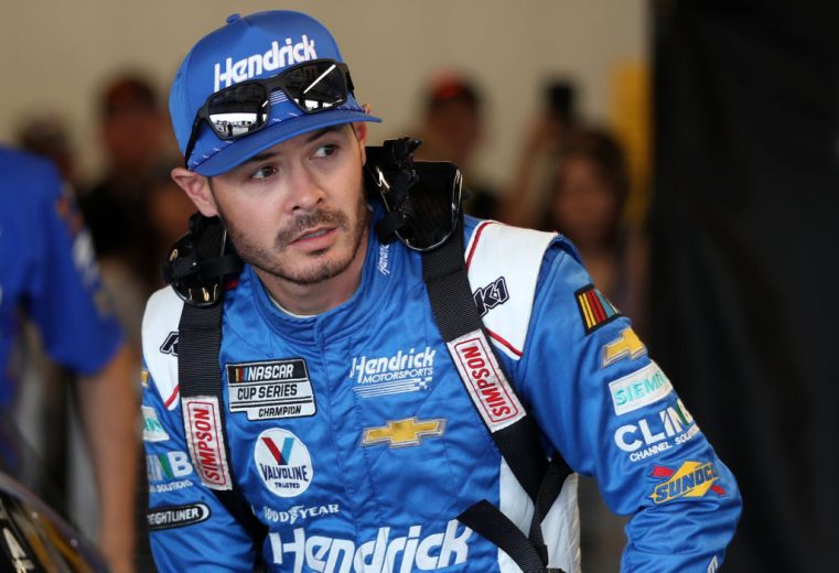 Kyle Larson looks onward in garage.