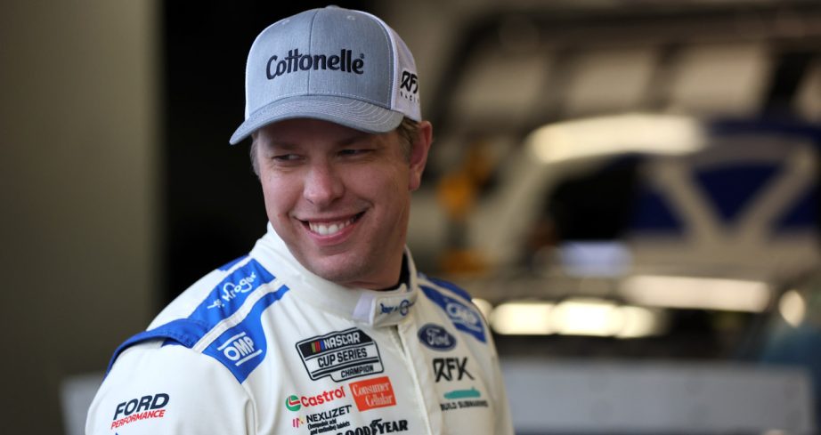 Brad Keselowski smiles in the NASCAR Cup Series garage.