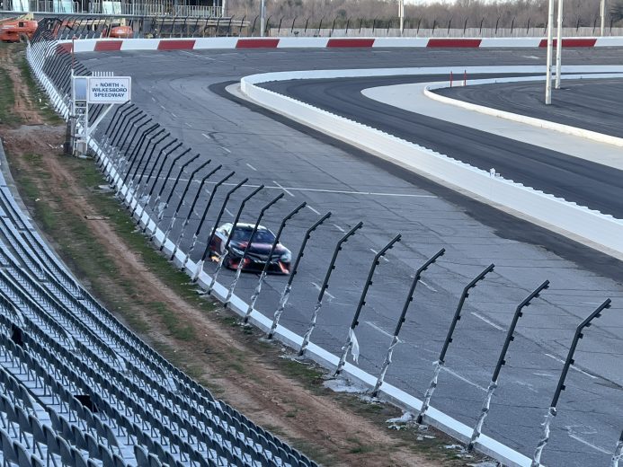 Flames shoot out of Tyler Reddick's car as he drives into Turn 1 at North Wilkesboro during testing