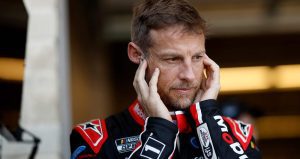 Jenson Button covers his ears in the NASCAR Cup Series garage at the Circuit of The Americas