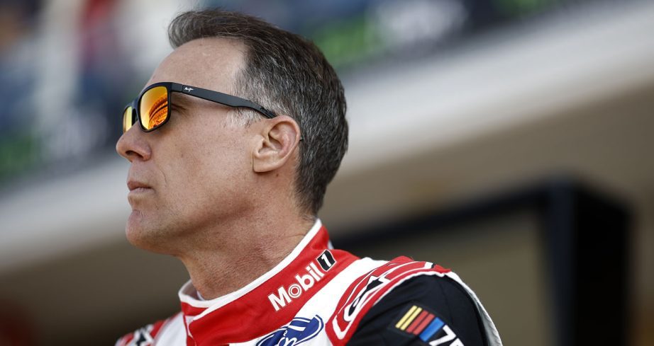 Kevin Harvick looks toward the sky with his sunglasses on.