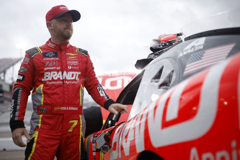 Justin Allgaier stands next to his car at Phoenix