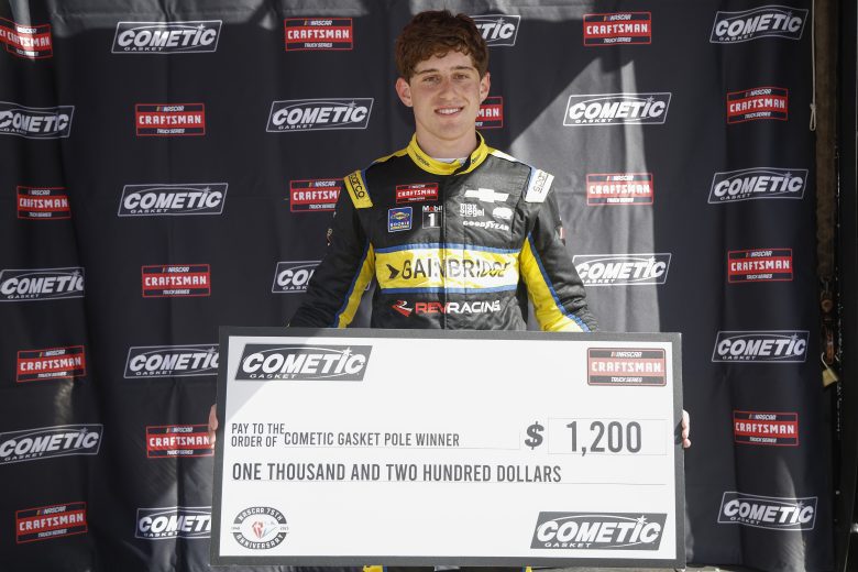 Nick Sanchez holds an oversized check after winning the Truck Series pole at Texas