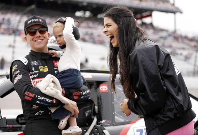 John Hunter Nemechek holds daughter Aspen and laughs with wife Taylor on pit road before the Xfinity race at Richmond