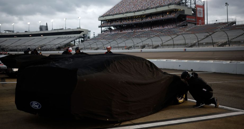 An Xfinity Series car sits covered on pit road at Richmond