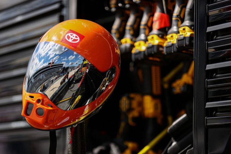 A pit crew helmet glistens in sun.