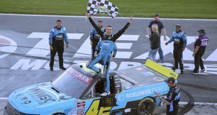 Carson Hocevar celebrates on top of his truck.