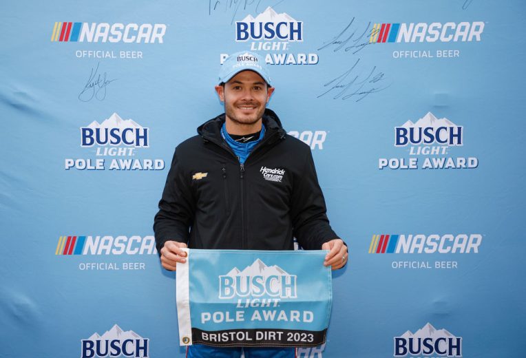 Kyle Larson poses with pole award