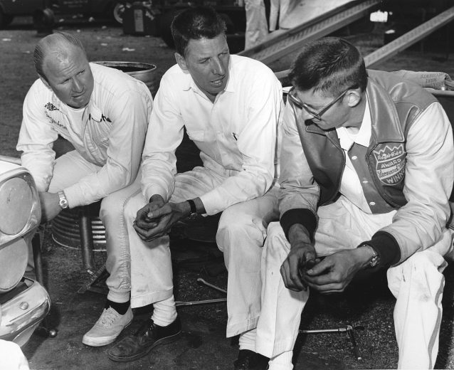 UNKNOWN — 1967: Driver Cale Yarborough (L) and his car owners Glen Wood (C) and Leonard Wood (R) talk strategy before a NASCAR Cup race. Yarborough won twice during the Cup season driving a Ford Fairlane for the Wood Brothers team. (Photo by ISC Images & Archives via Getty Images)
