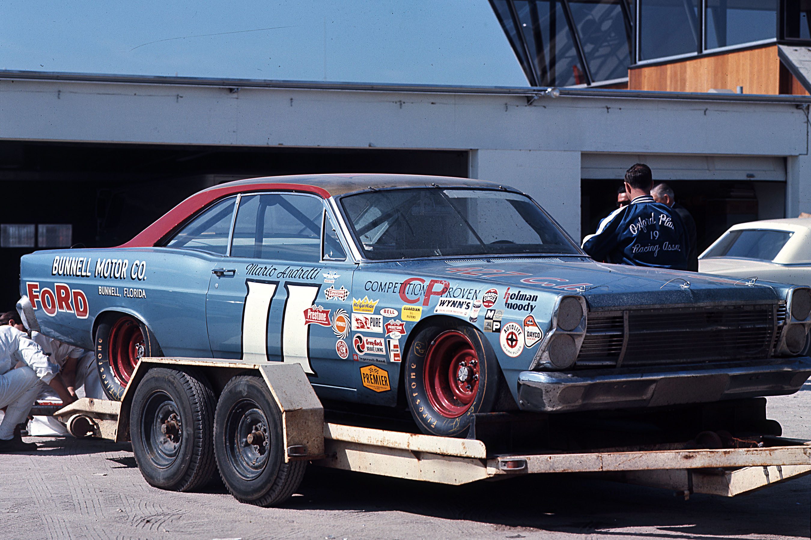 DAYTONA BEACH, FL -Ê1967: Unlike the huge race car haulers used in NASCAR Cup racing today, Mario AndrettiÕs Daytona 500 race-winning Holman-Moody Ford was brought to Daytona International Speedway on a simple tandem-axle open trailer. (Photo by ISC Images & Archives via Getty Images)