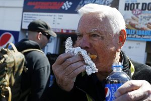 In this 2015 photo, NASCAR Hall of Famer Junior Johnson eats a hot dog at Martinsville