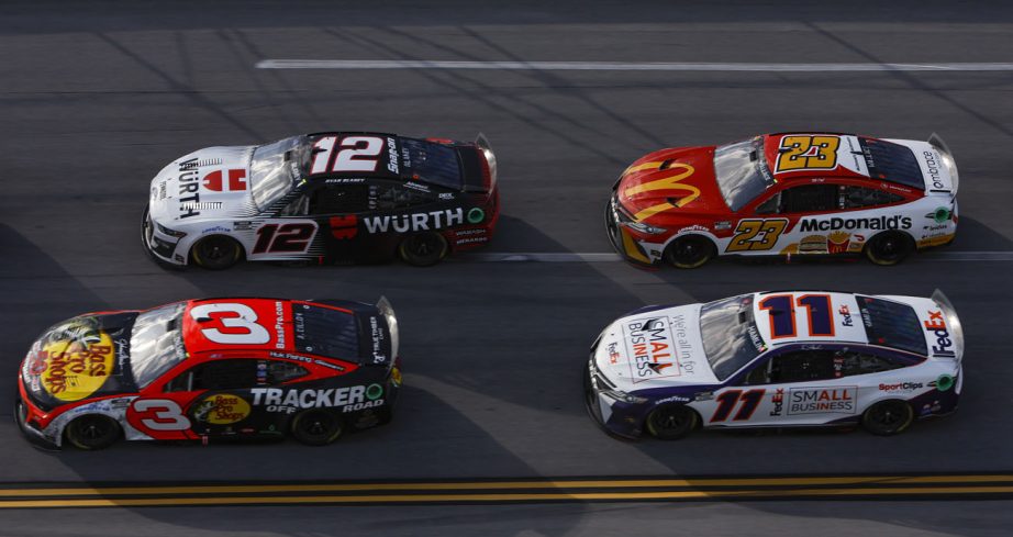 Cars race around Talladega.