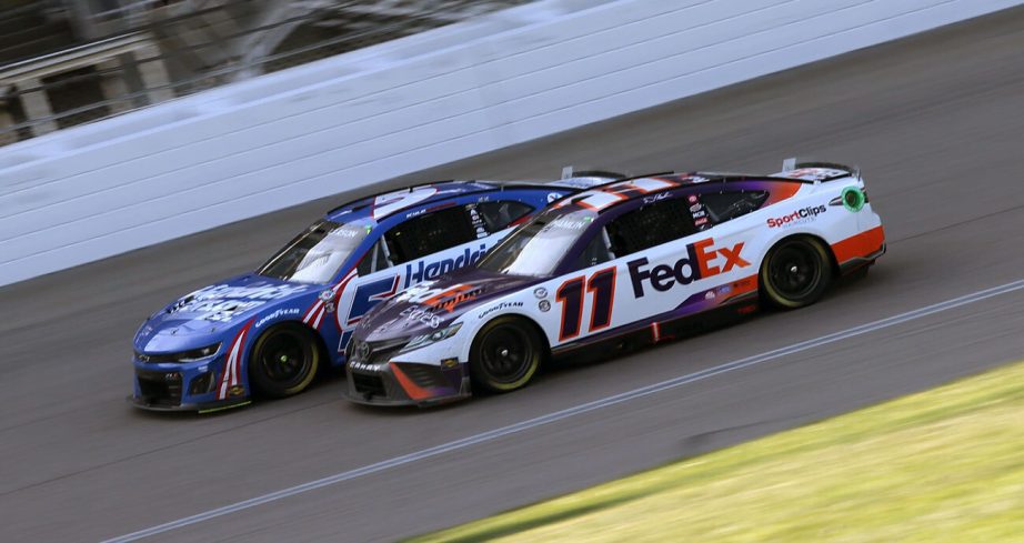 Denny Hamlin (11) and Kyle Larson race side by side in the late going at Kansas Speedway