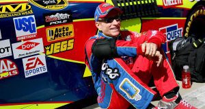 Mark Martin sits next to car.